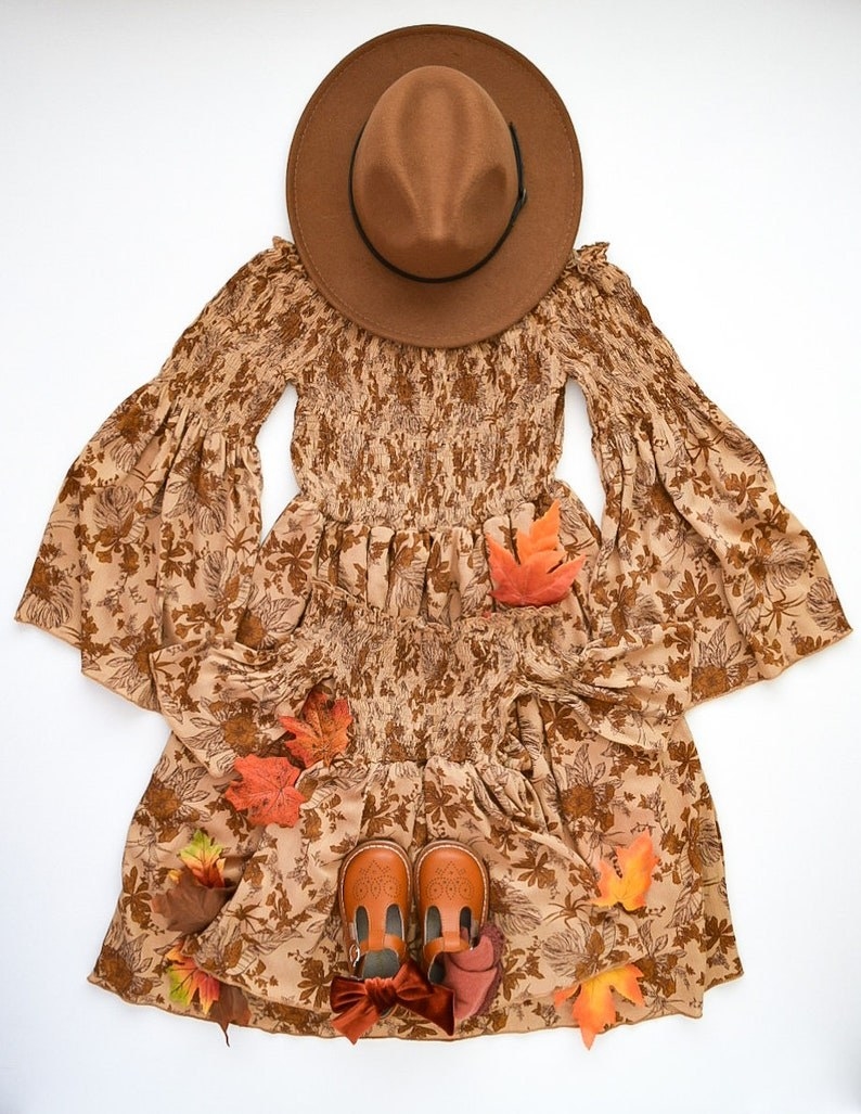 the brown smock dress with a leaf print on it