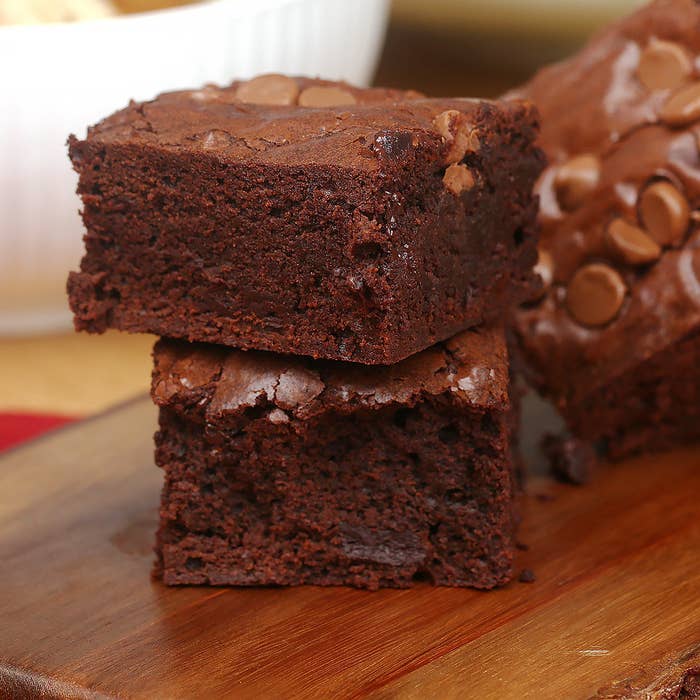 A stack of brownies on a plate.
