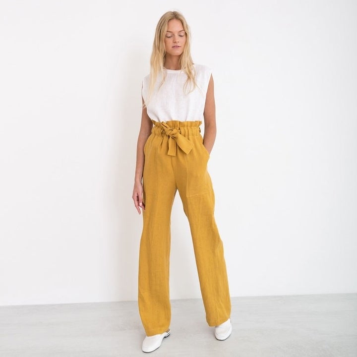 a model wearing the pants in yellow