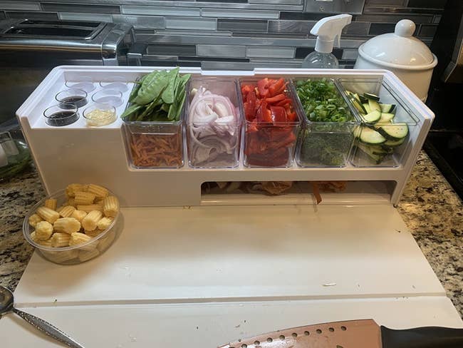 Reviewer photo of the white meal prep station with various vegetables in each compartment