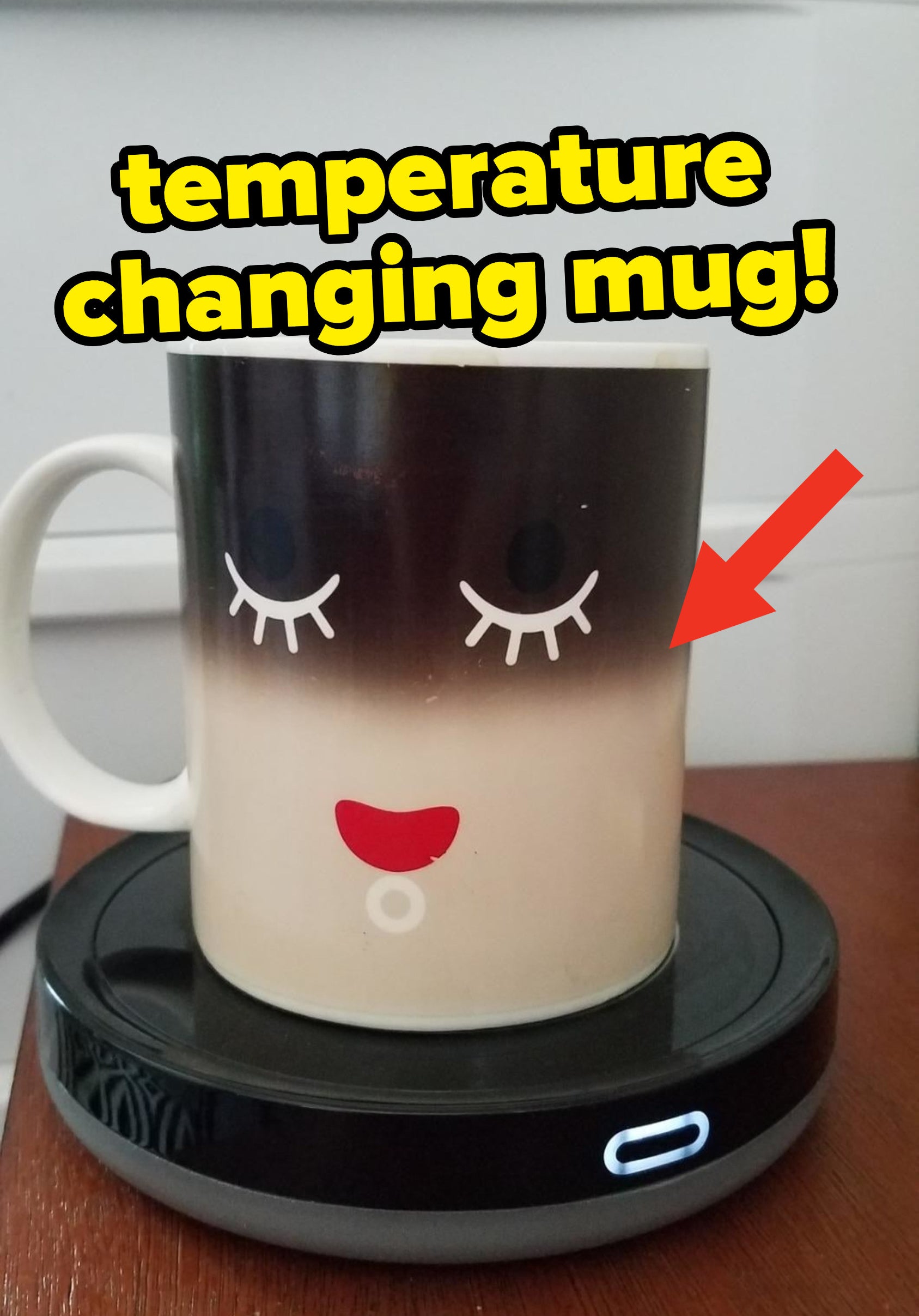 A temperature changing mug on top of a mug warmer, showing that the coffee inside is warm based on the color change
