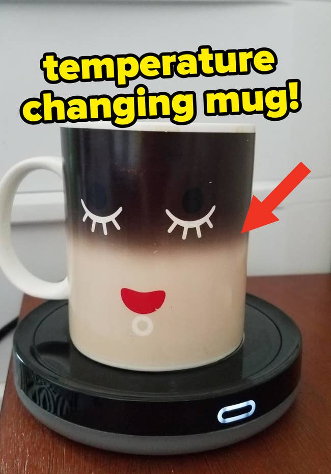 Reviewer photo of a temperature changing mug on top of a mug warmer, showing that the coffee inside is warm based on the color change