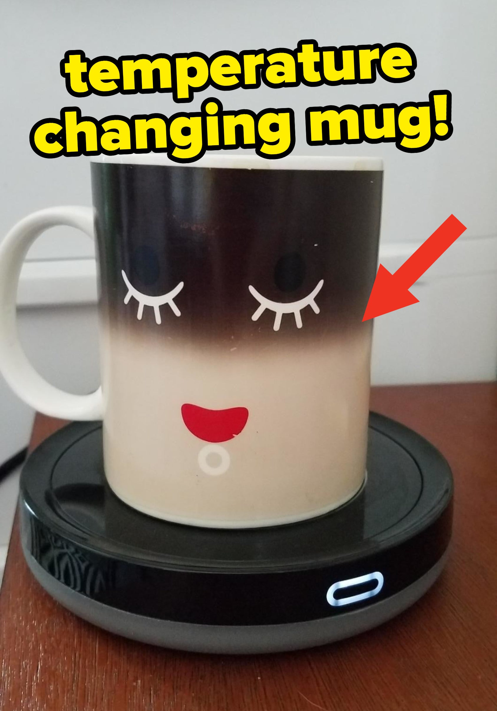 A temperature changing mug on top of a mug warmer, showing that the coffee inside is warm based on the color change