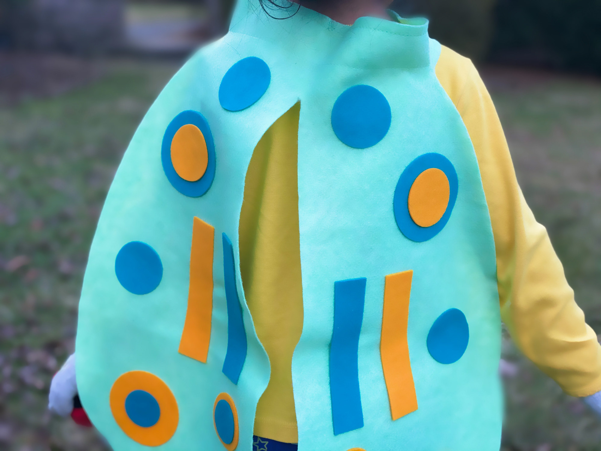 A child in a felt bug costume.