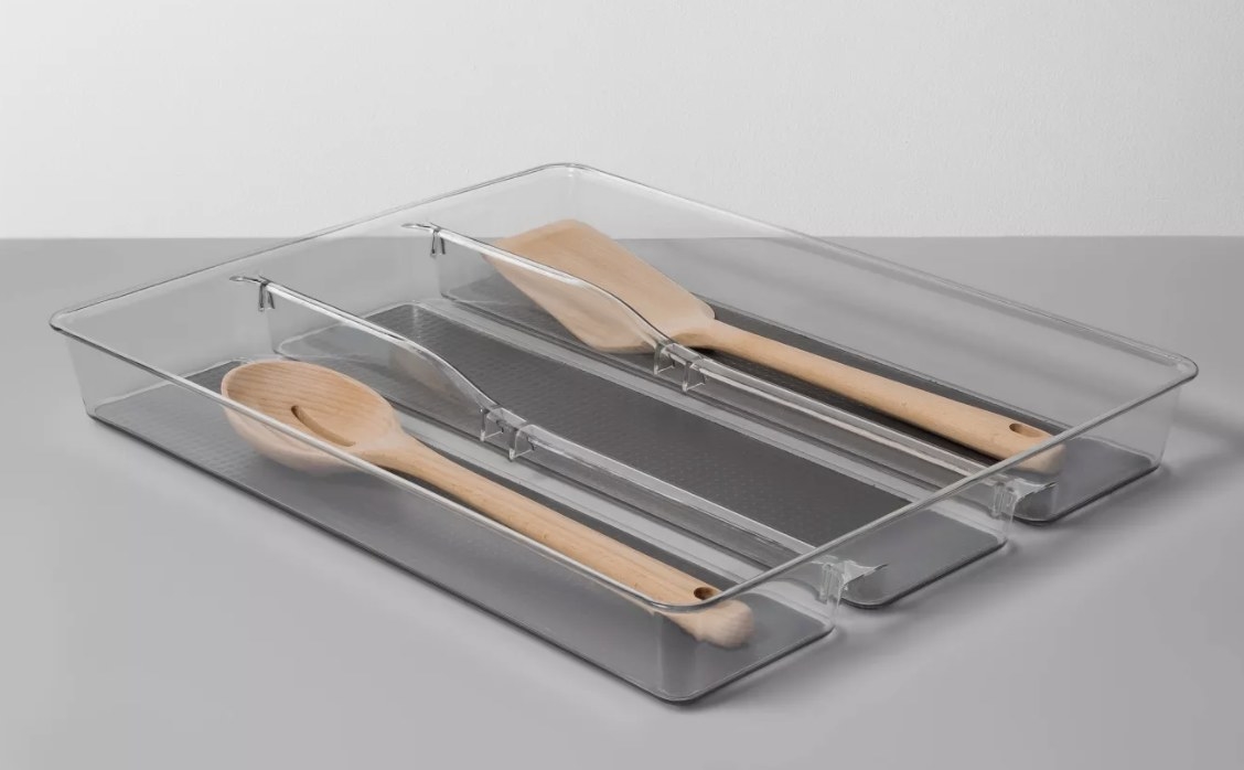a three compartment organizer holding wooden spoons