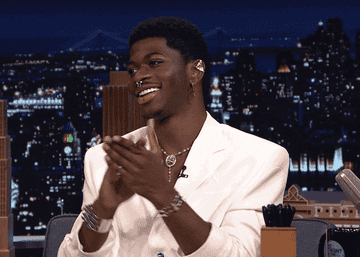 Lil Nas X clapping while being a guest on the Jimmy Fallon Late Night Show