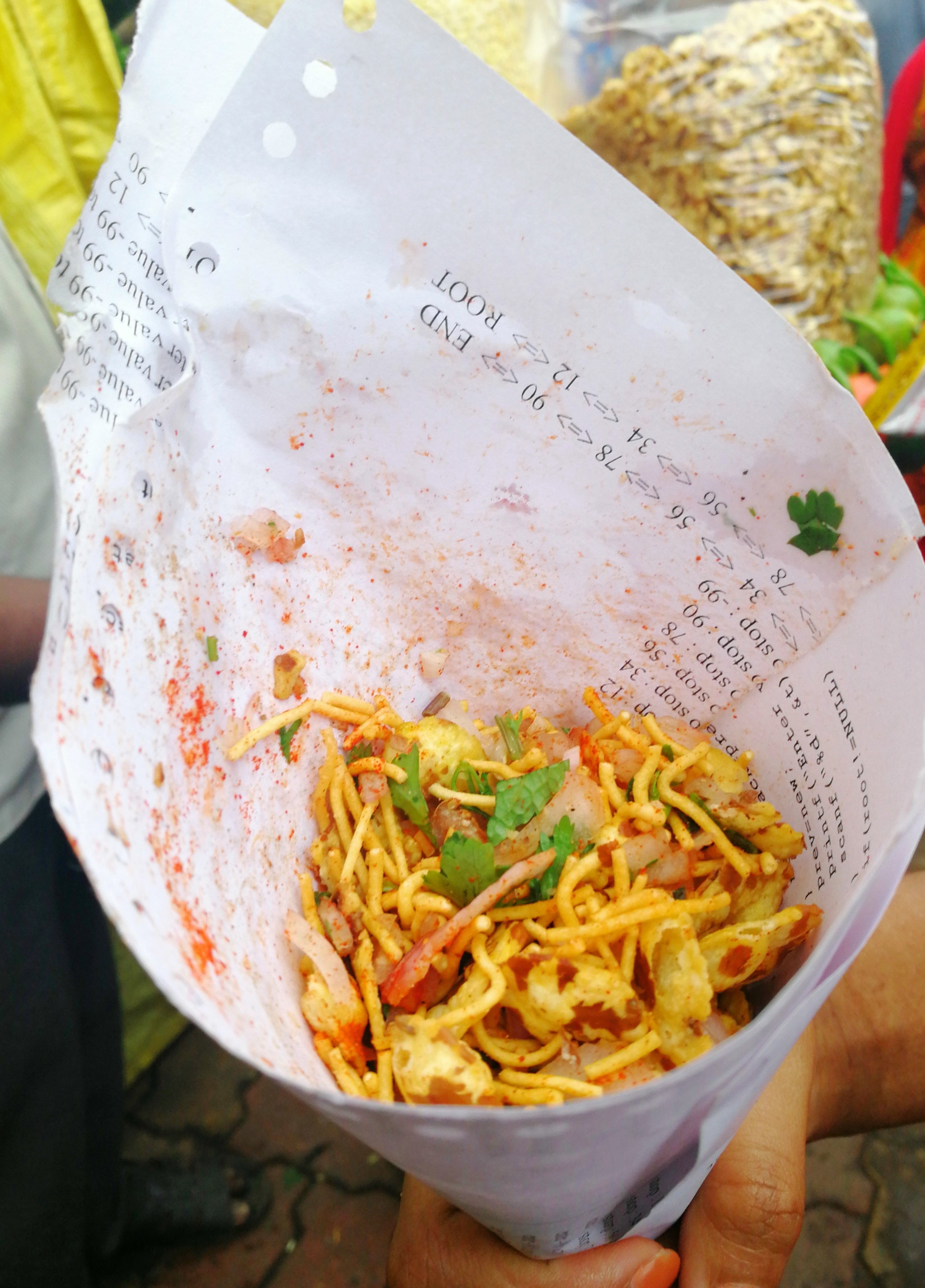Some bhel served in a packet made out of paper