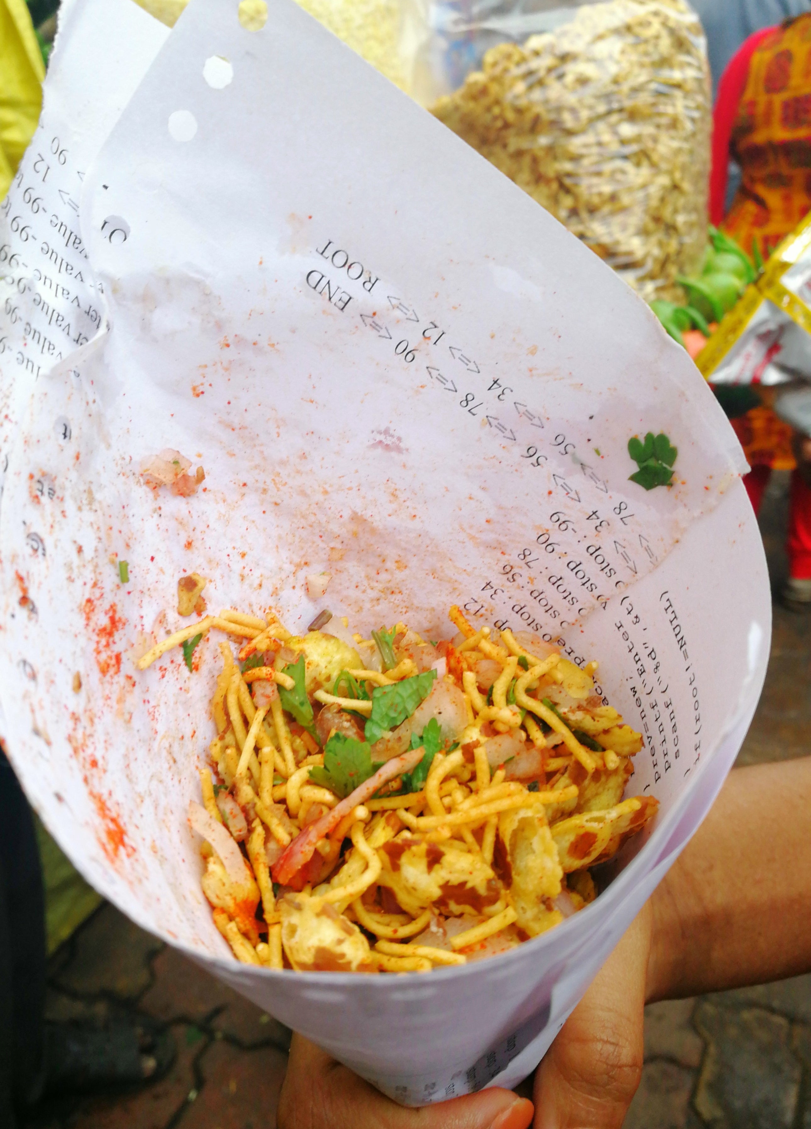 Some bhel served in a packet made out of paper