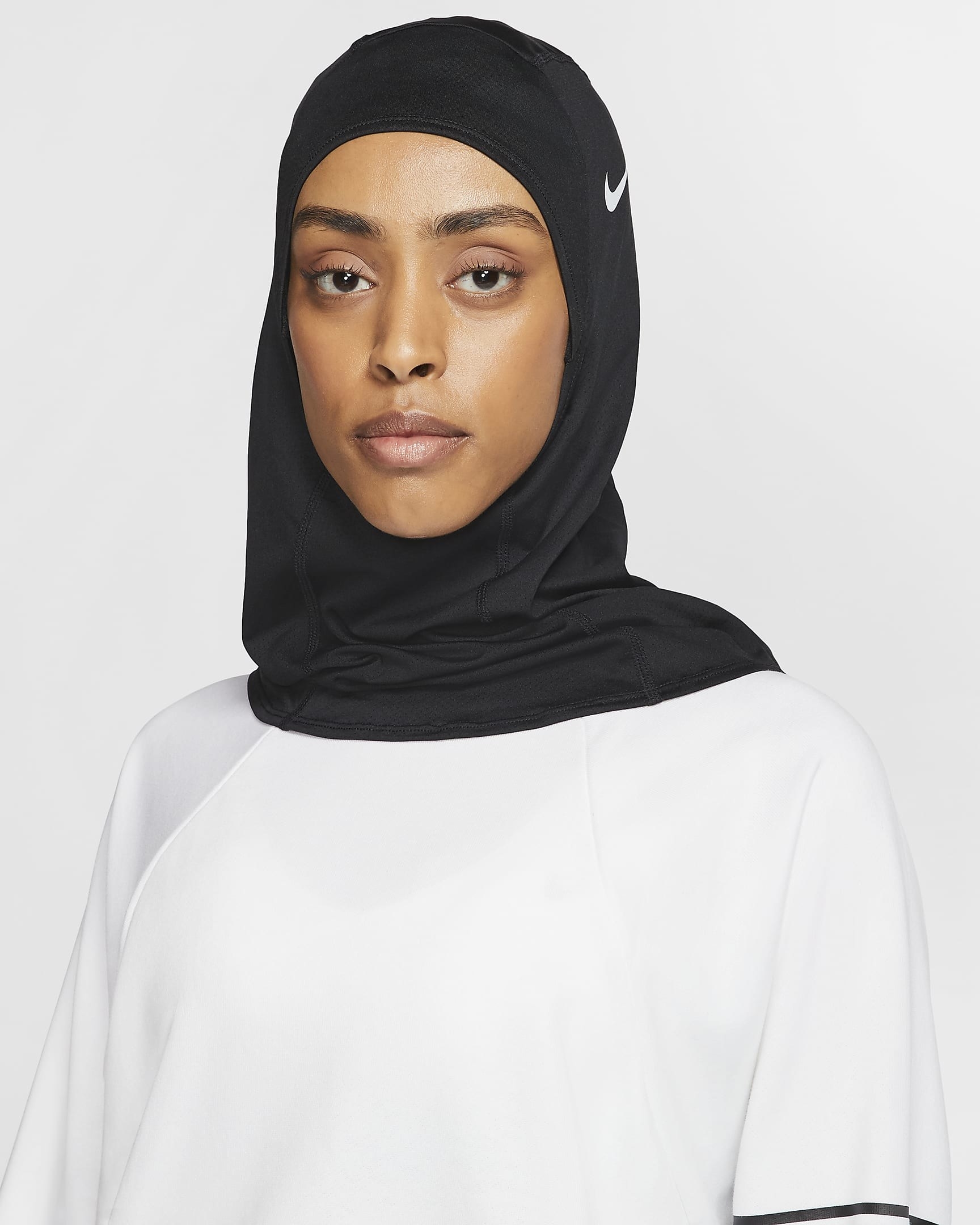 Model wearing black hijab with white nike check logo