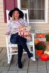 Close-up of woman sitting on the porch and holding the &quot;Blessed&quot; pillow