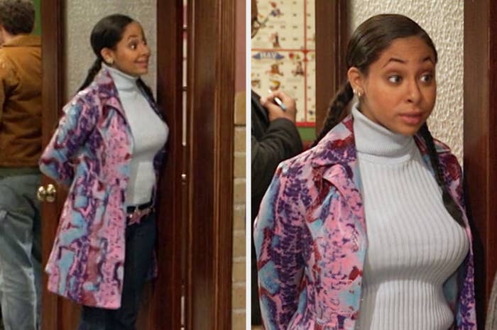 Raven wearing a multicolor faux snakeskin coat and a ribbed turtleneck with jeans