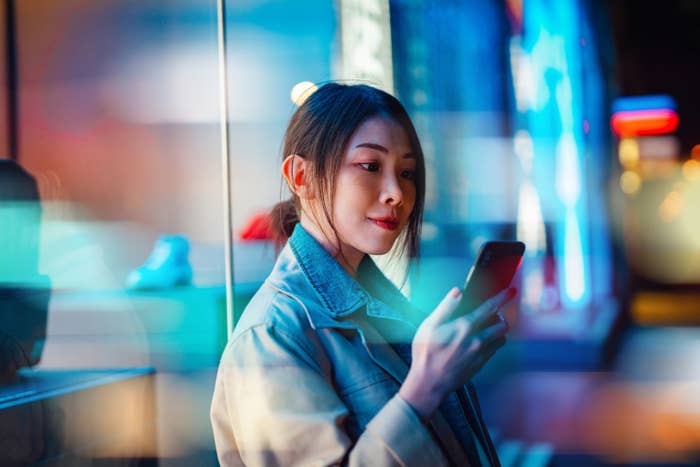 Young woman looking at finances on her phone