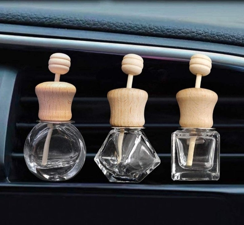 small glass bottles with wood lids clipped to an air vent
