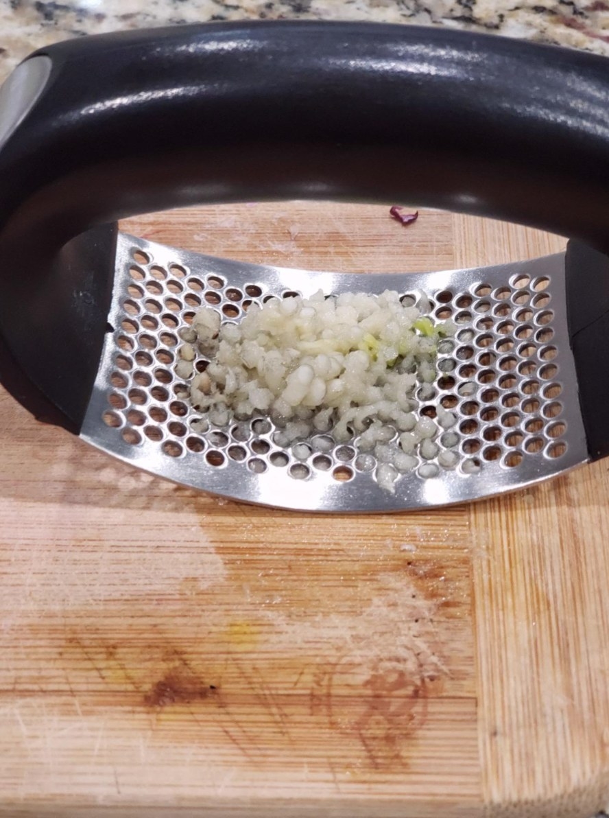 the reviewer&#x27;s image of the garlic press