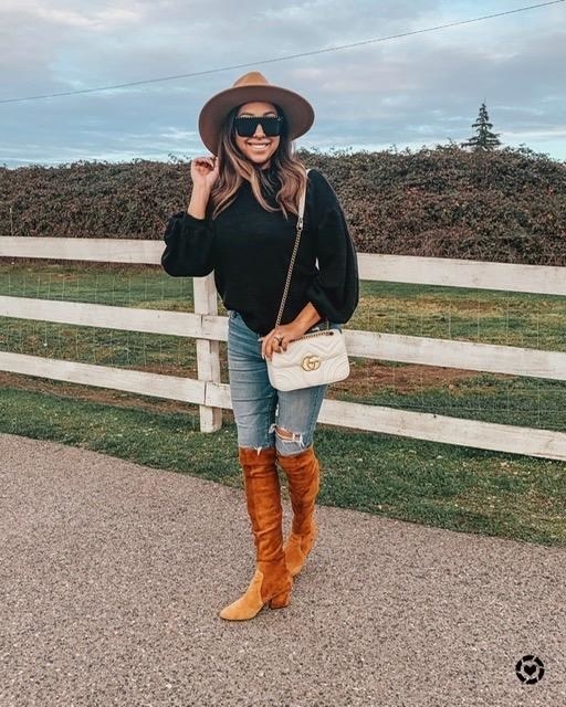 a reviewer in the sweater in black