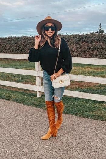 a reviewer in the sweater in black