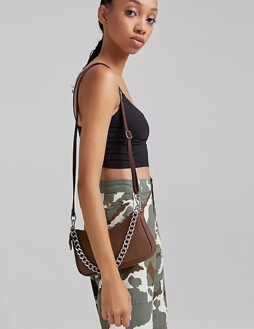 Model wearing the brown bag on her shoulder