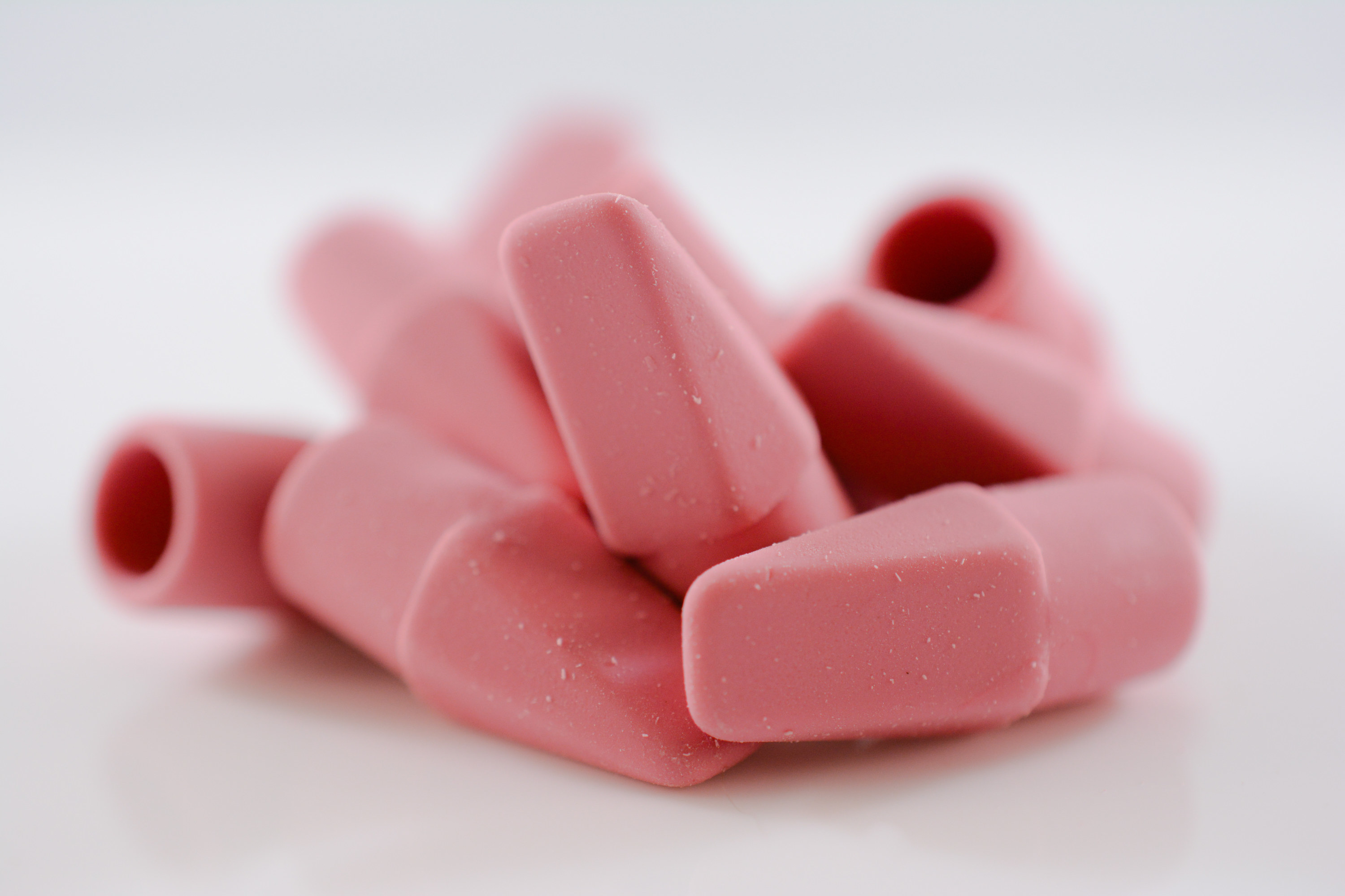 Photo of pencil top erasers in a pile against a white background