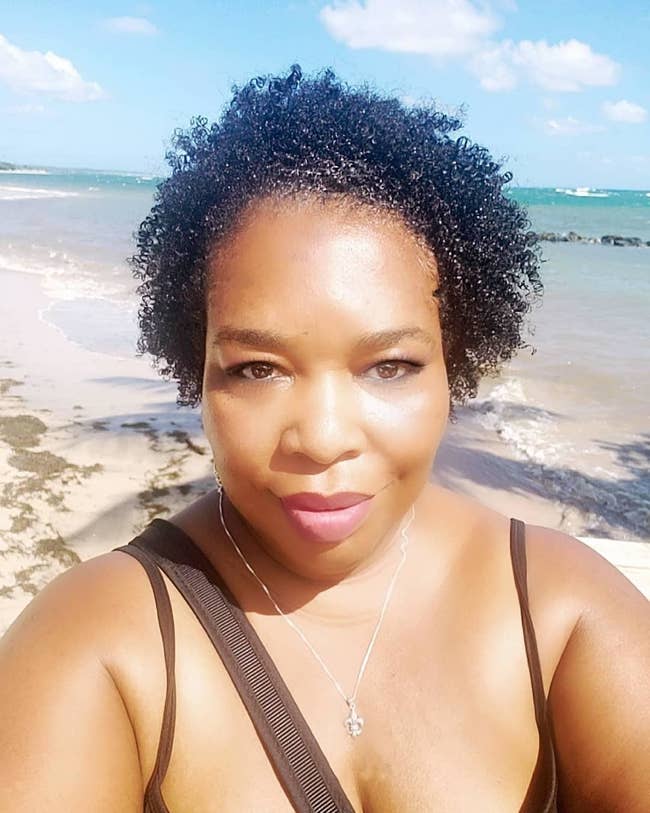 reviewer with natural hair that looks moisturized and defined