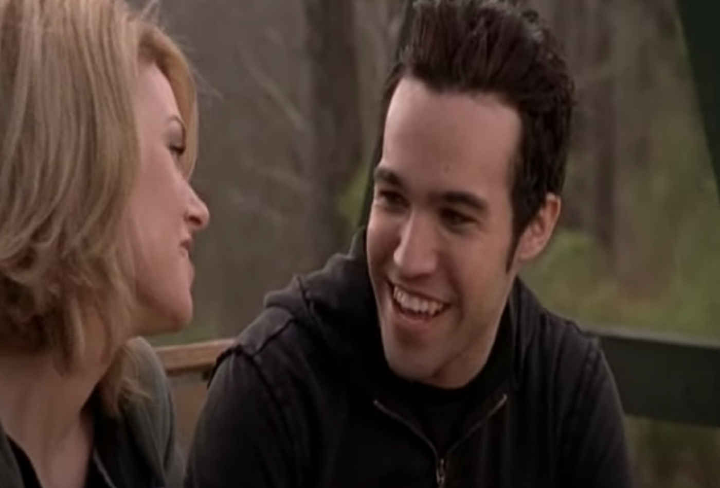 Pete talking to Peyton on a wooden swing bench