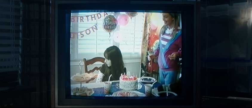 Old VHS tape of girl&#x27;s birthday party being played on a TV