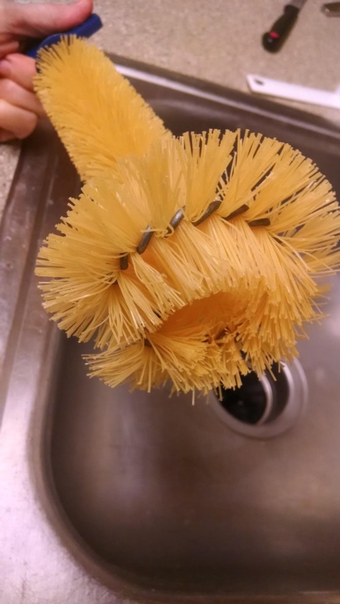 the reviewer&#x27;s image of the yellow disposable brush