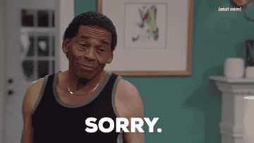 GIF of man saying &quot;Sorry, shit happens&quot;