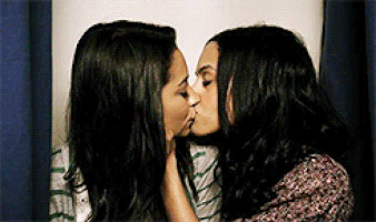 Emily and Maya kiss in the photo booth
