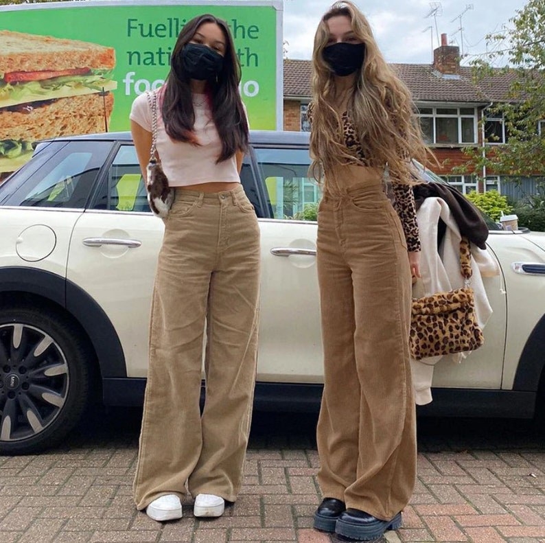 two models wearing two different shades of the brown corduroy pants