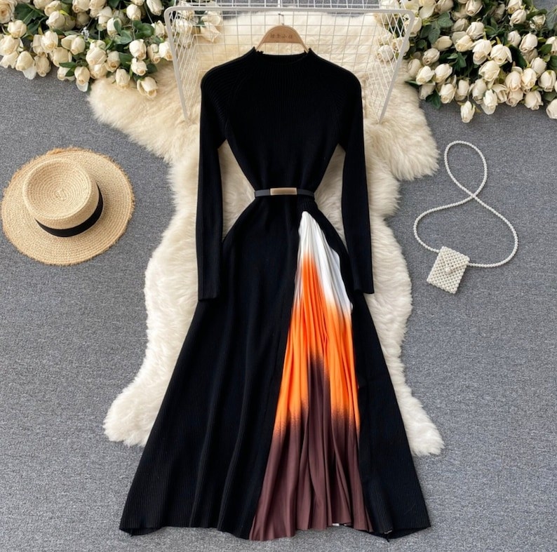 the black dress with a white, orange, and brown ombre slit