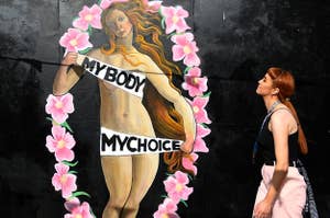 "The Birth of Venus" art holding banners saying, "My body, my choice"