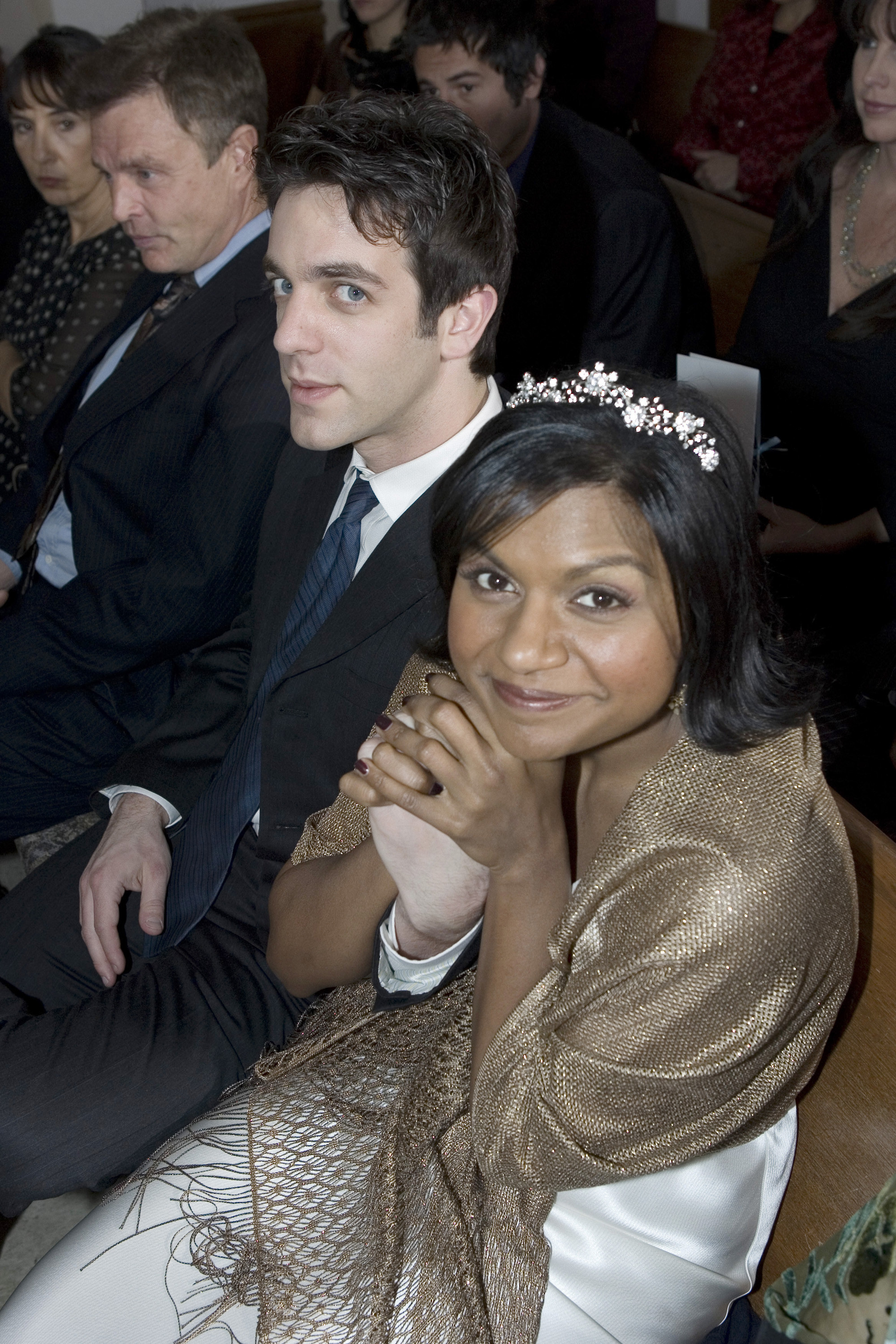 Kelly holds onto Ryan&#x27;s hand while sitting in the pew of a church