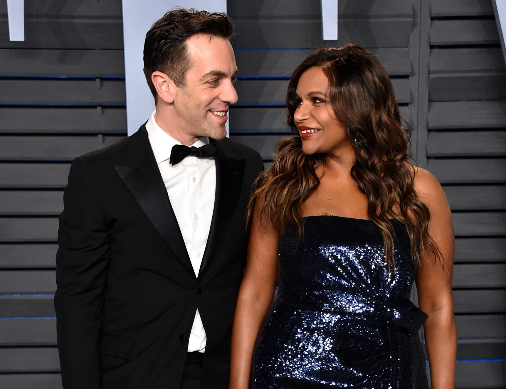 Mindy and B.J. look at each other and smile at an event