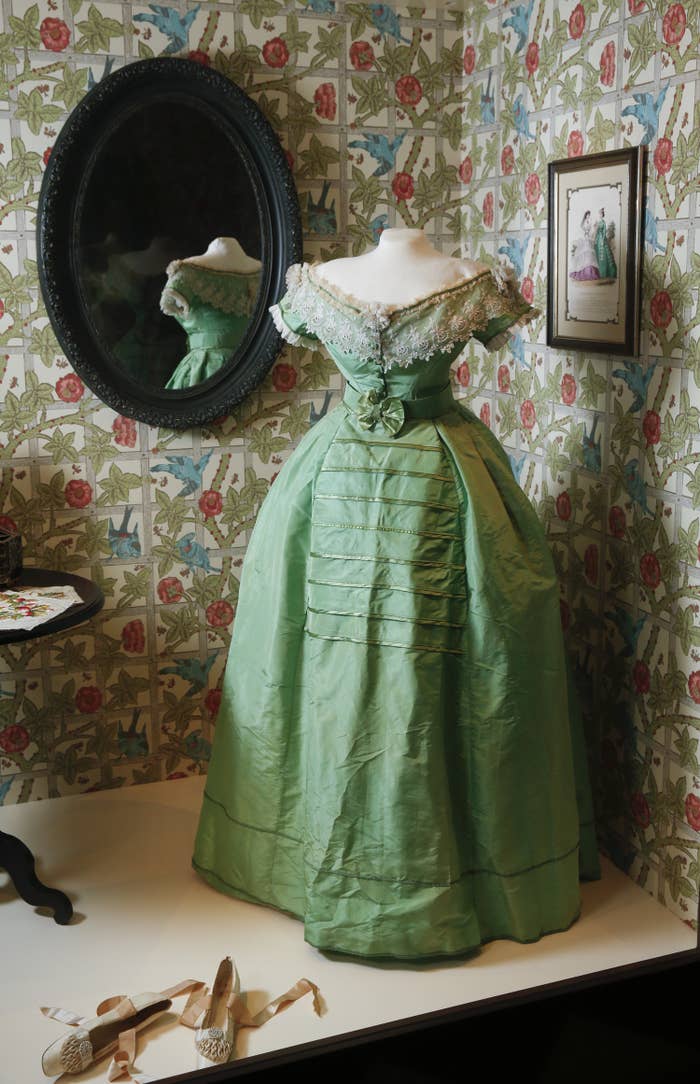 A photo of a green dress on display with traces of arsenic.