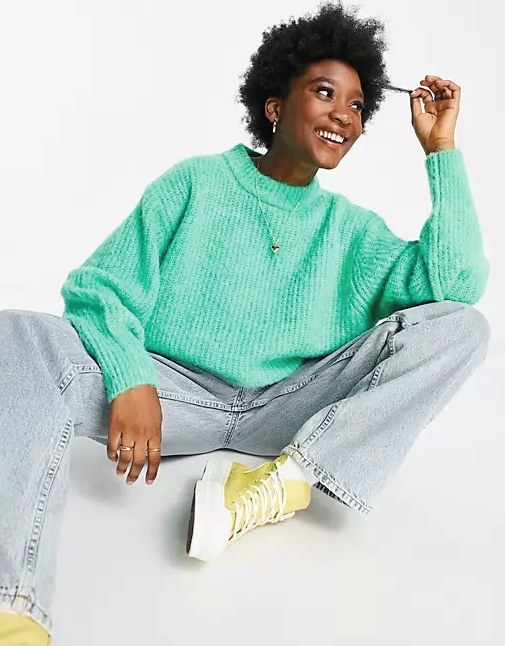 Model wearing the ribbed knit sweater