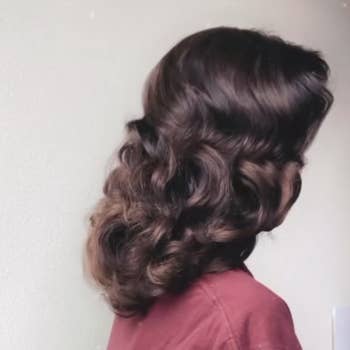The same reviewer with the finished look, with shiny vintagey brushed-out curls