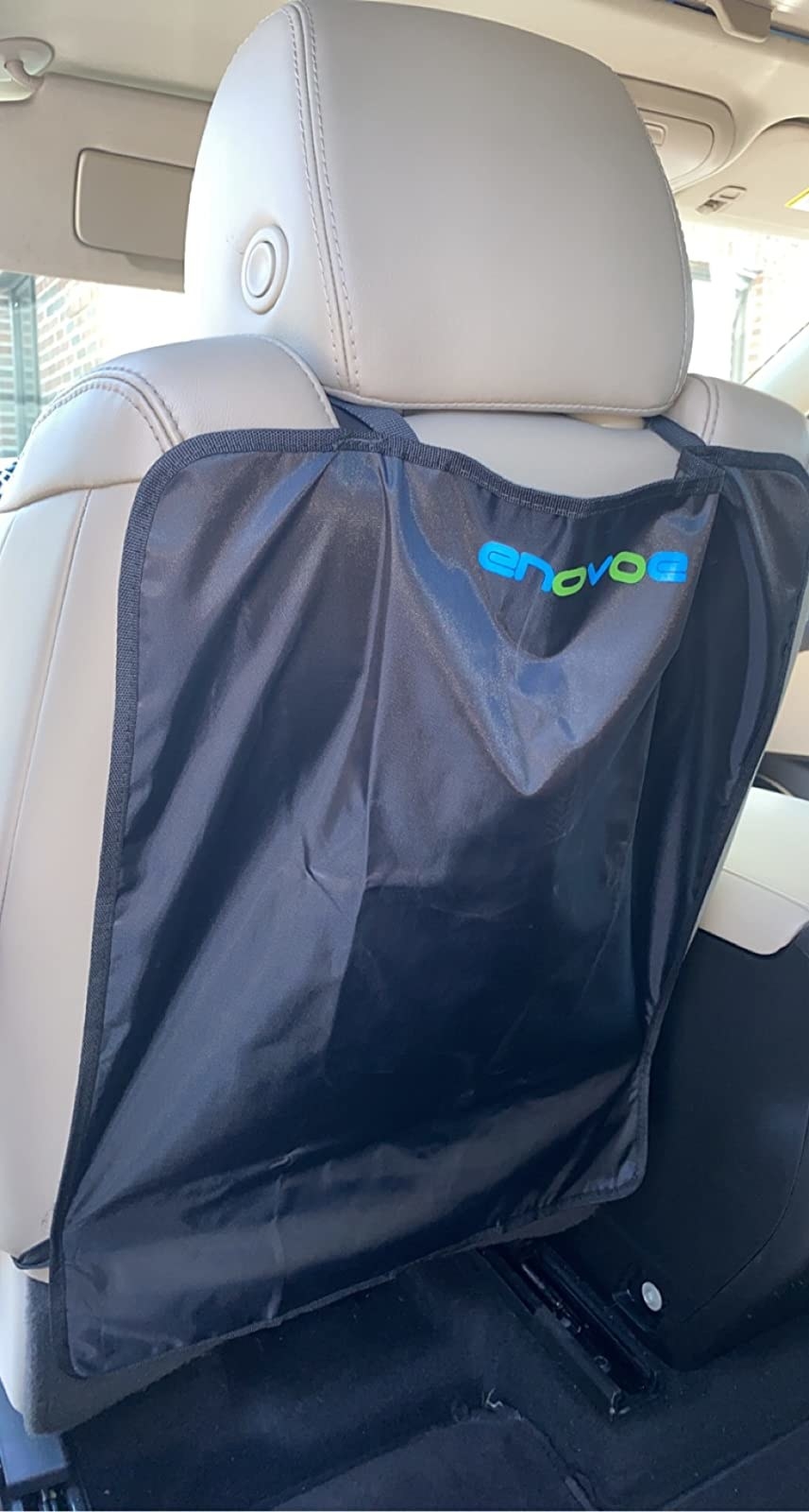 reviewer photo of the black mat over a tan seat