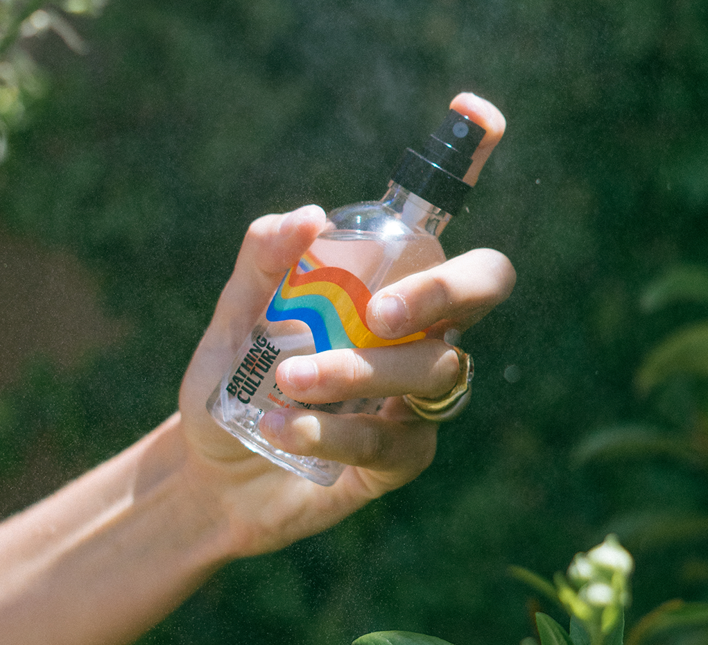 A clear spray bottle with rainbow design