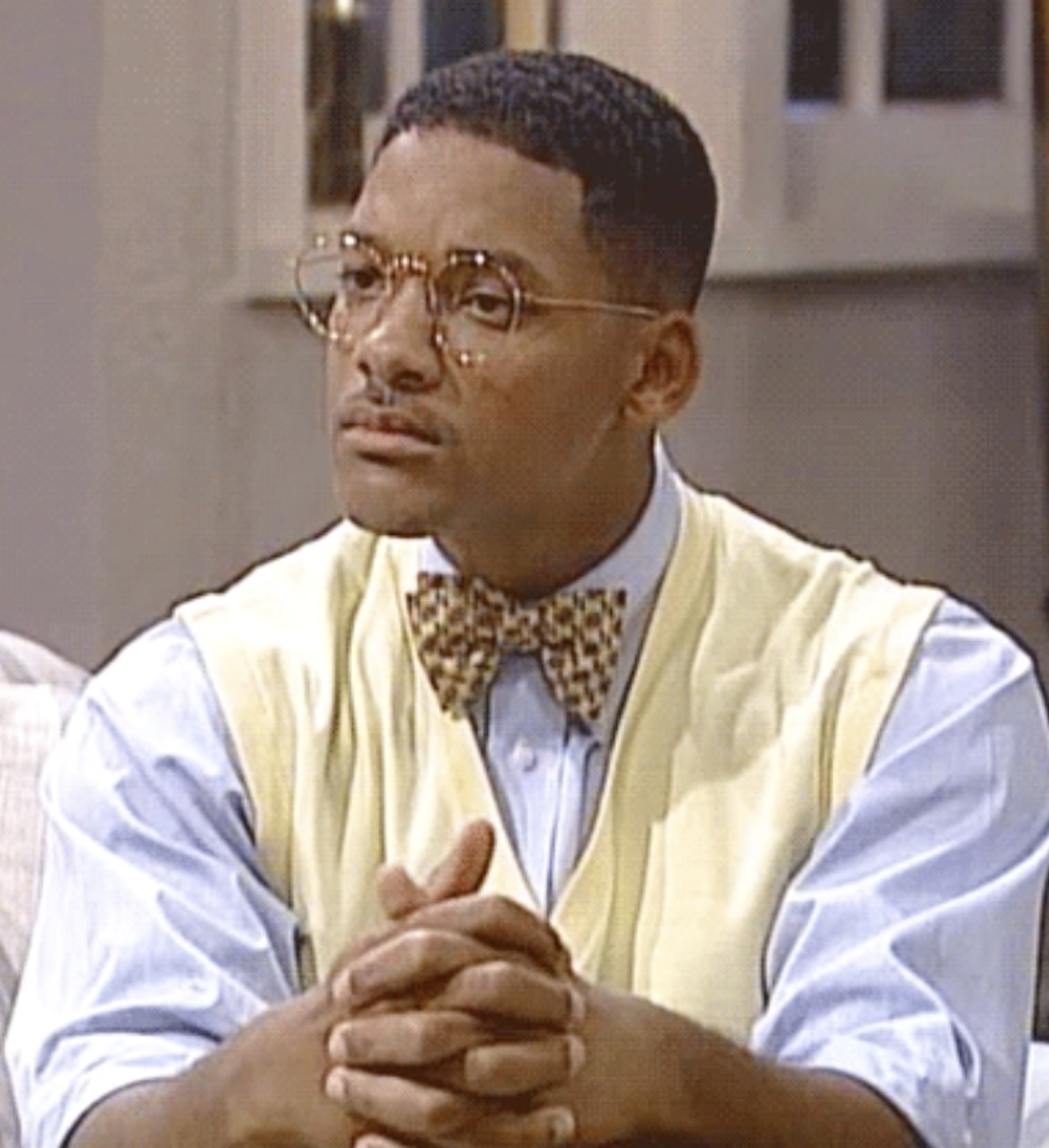Will Smith in &quot;The Fresh Prince of Bel-Air&quot; quizzically looking at someone, his hands folded on his knees