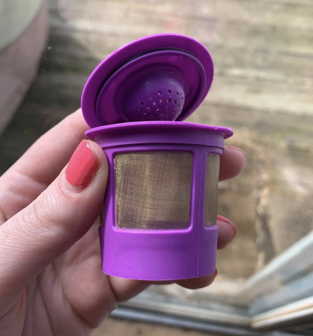 reviewer holding up the purple reusable filter