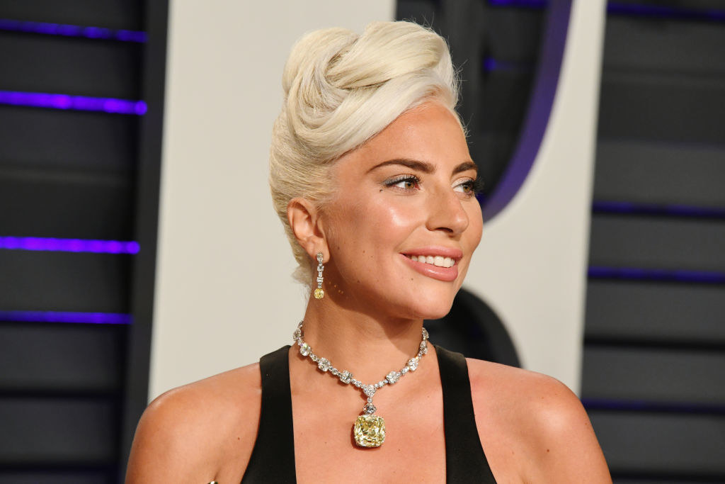 Lady Gaga at the Oscars with an elaborate updo and canary yellow diamond necklace