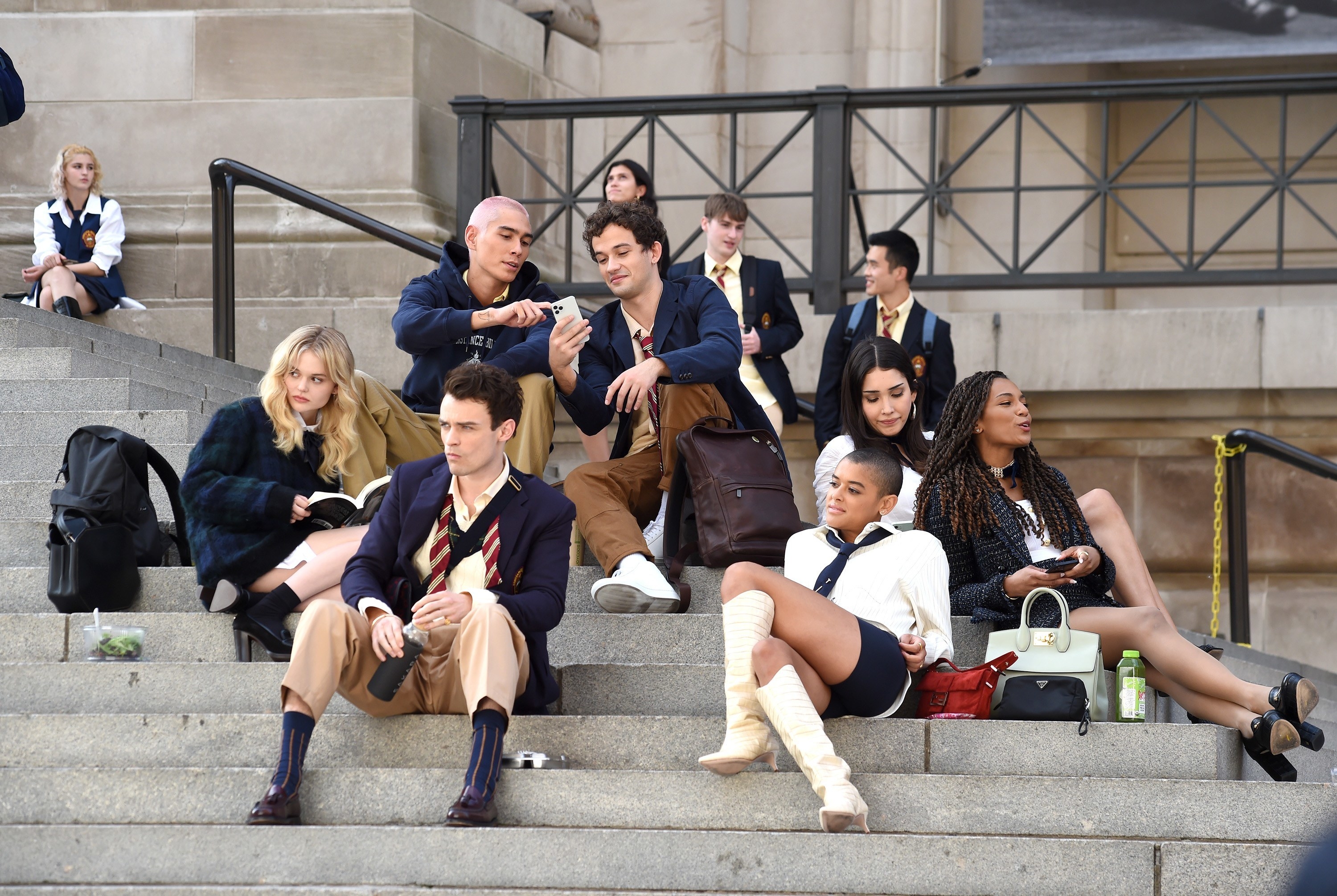 Aki, Julian, Luna, Monet, Max, Obie, and Audrey from the &quot;Gossip Girl&quot; reboot sitting on the MET stairs