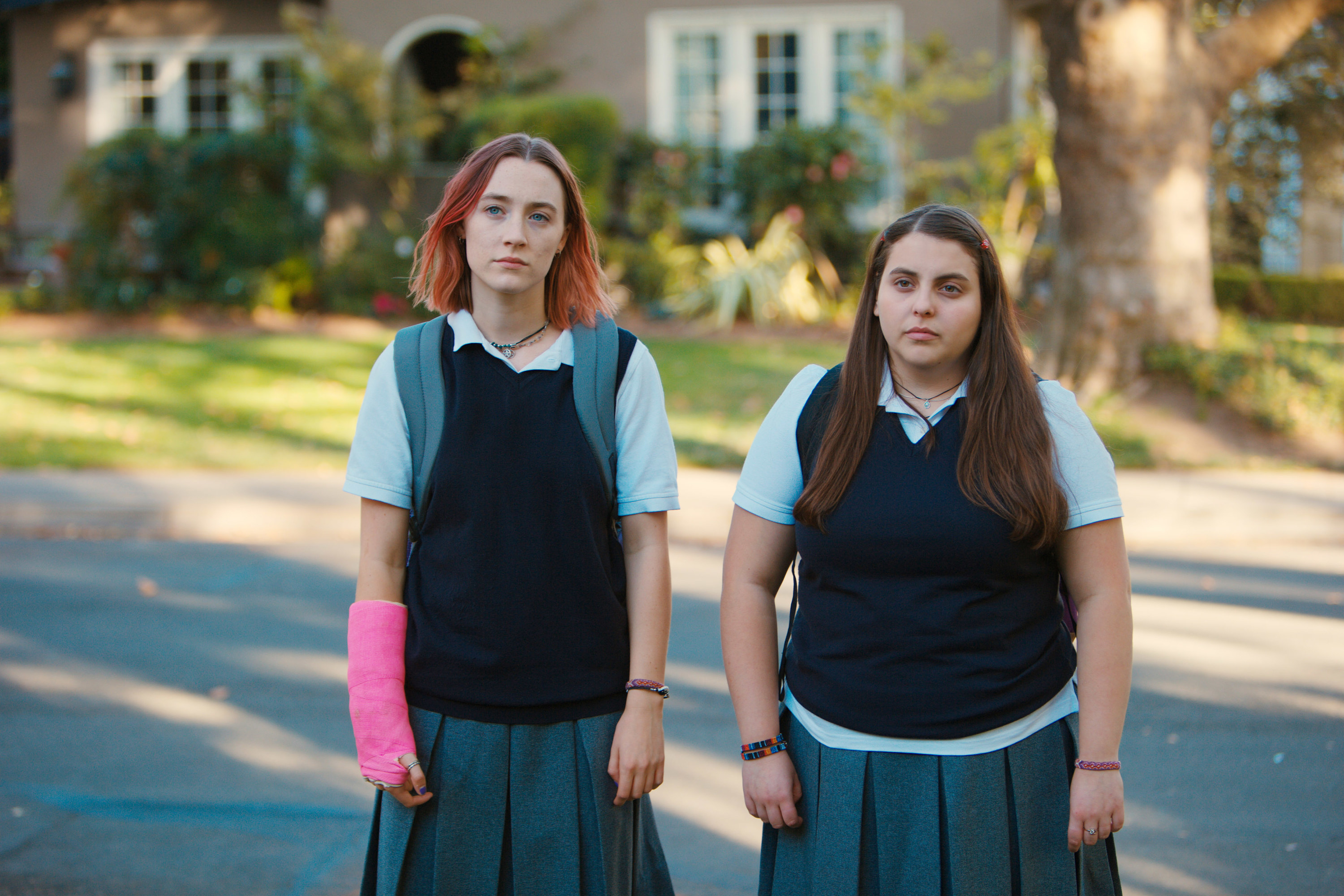 Christina and Julie standing in a parking lot on &quot;Lady Bird&quot;