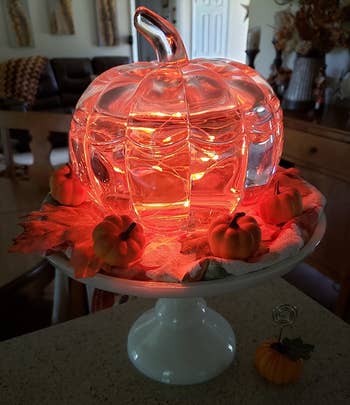 a reviewer's lights inside of a glass pumpkin