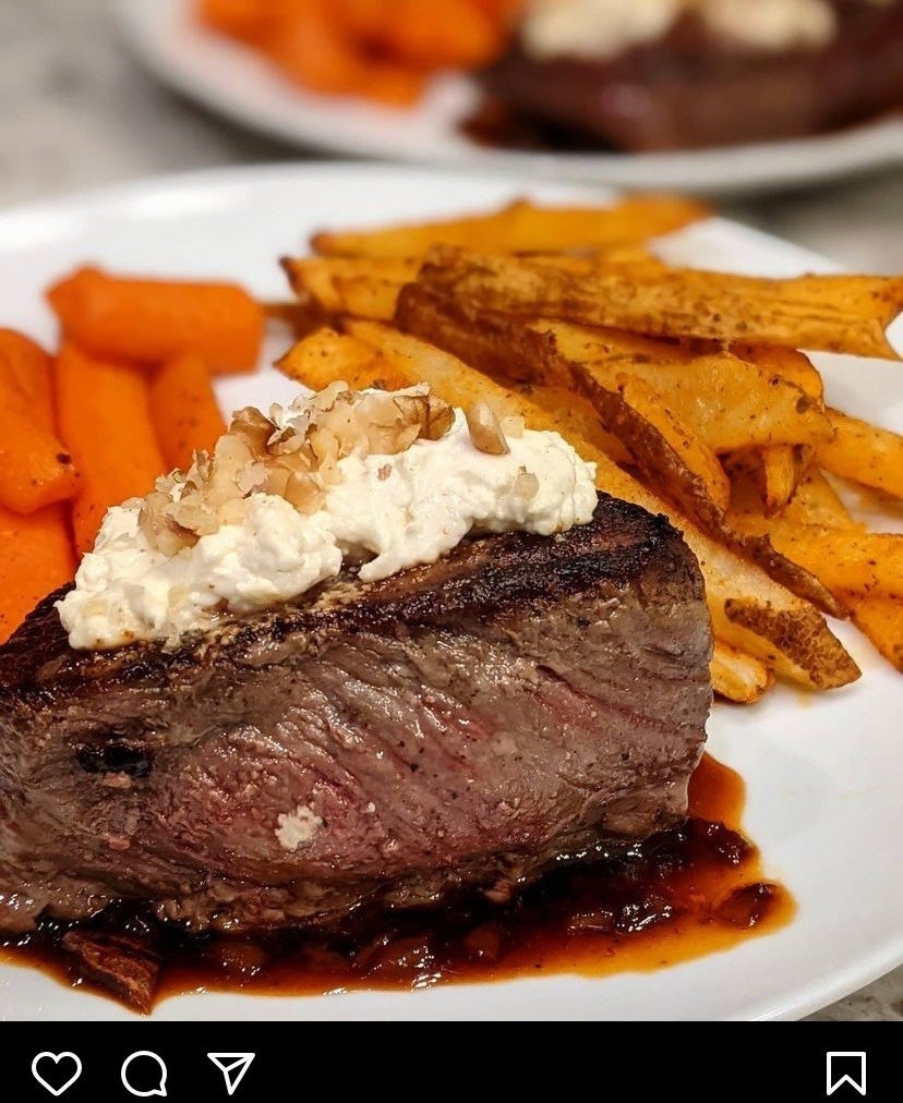 A picture of steak with french fries and carrots