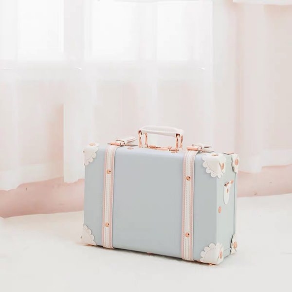 The suitcase in blue with a handle and white accents throughout