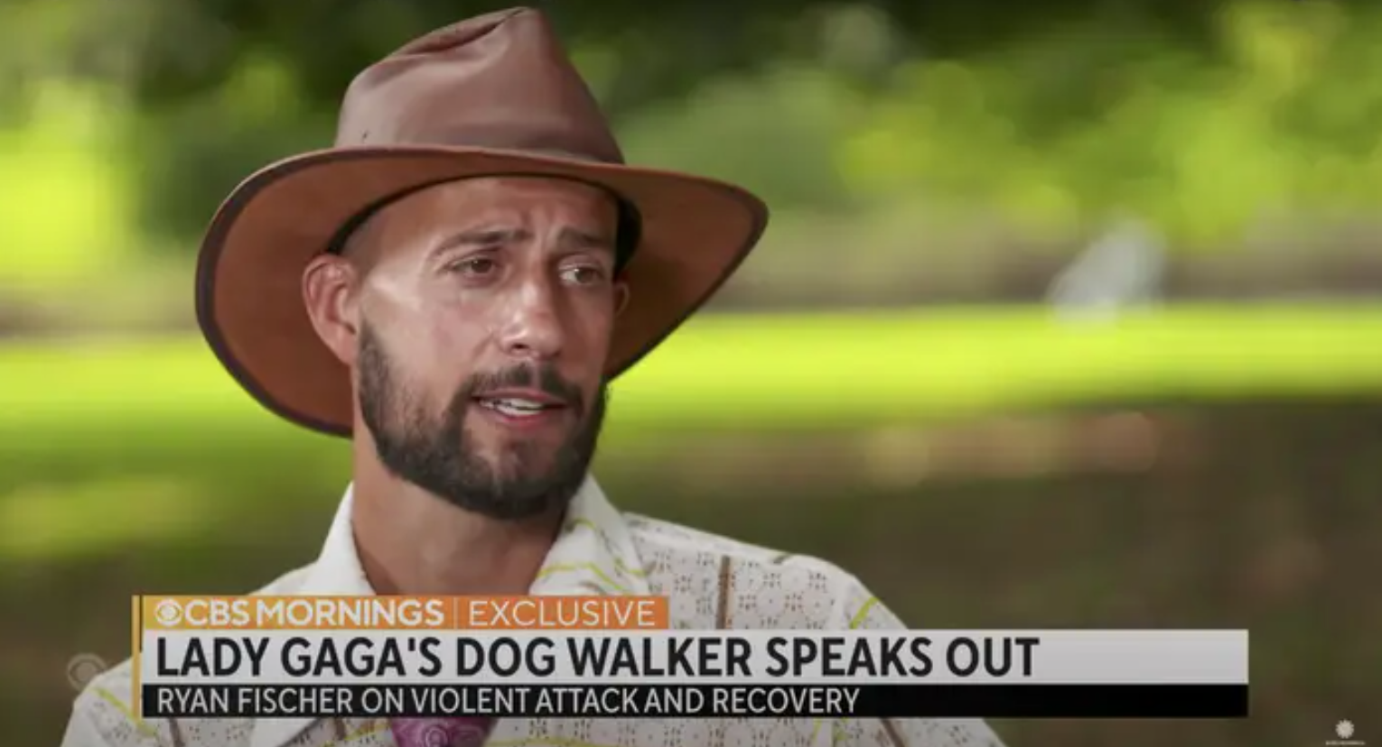 Still from an interview with Ryan Fischer with a chyron: Lady Gaga&#x27;s Dog Walker Speaks Out