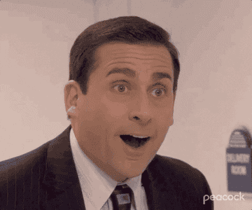 A gif of Michael Scott from The Office looking shocked and happy