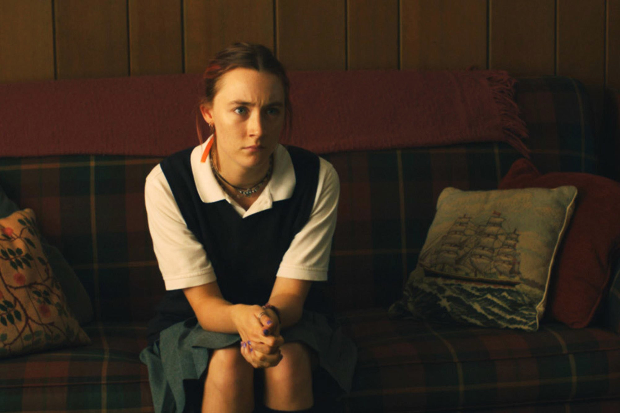 Christina sitting on a couch in her school uniform on &quot;Lady Bird&quot;