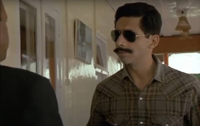 A young Naseeruddin Shah in a checkered shirt and black aviators